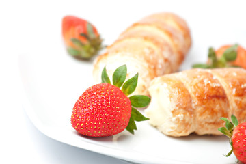 Strawberry and puff pastry rolls filled with cream