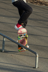 Skateboarder jumping to make railslide