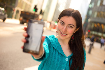 young woman showing the screen of her phone