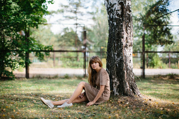 young beautiful girl posing in the park