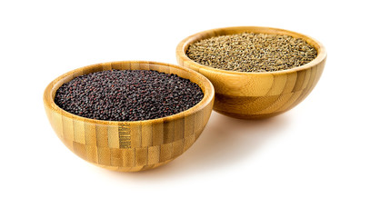 Wooden bowls with black mustard and cumin pods