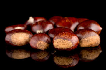 Chestnuts on a black reflective background