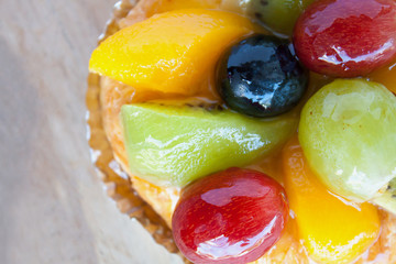 close up danish pastry with fruit on wood table