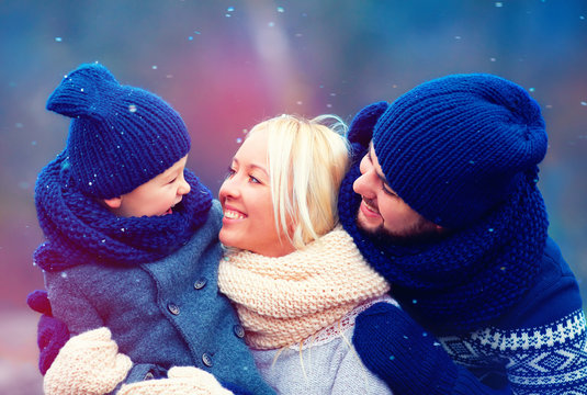 Happy Family Having Fun Together Under Winter Snow