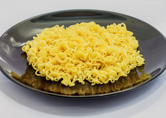 The half egg noodles is in a black dish