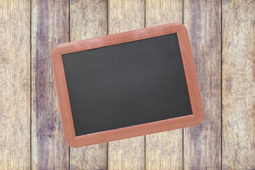 Small blackboard on old wood background