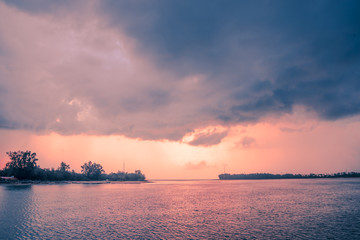 Fototapeta na wymiar Rain clouds during sunset sea- Stock Image