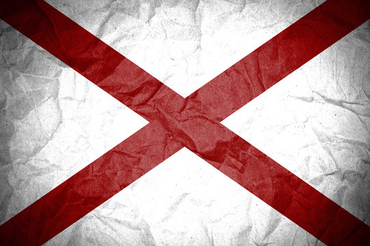 Grunge of Alabama flag on crumpled paper