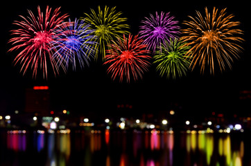 Fireworks celebration and the city night light background.