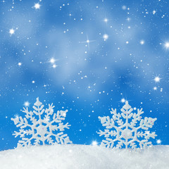 Fototapeta na wymiar Christmas background with two decorative snowflakes in snow