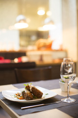 Grilled meat with sauce and herbs served at restaurant