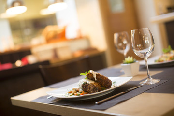 Grilled meat with sauce and herbs served at restaurant
