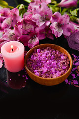 Fototapeta na wymiar Spa background-branch orchid, candle, petals in bowl
