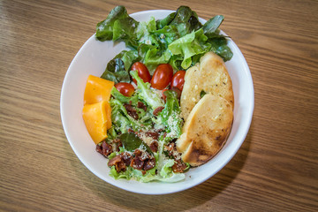 Fresh salad with becon ,cheese  and tomato. Top view