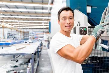 Asian worker in production plant on the factory floor