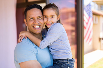 middle aged american man holding his daughter