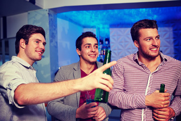 group of male friends with beer in nightclub