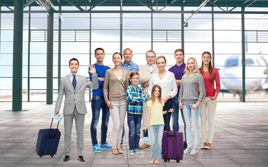 group of smiling people over airport terminal