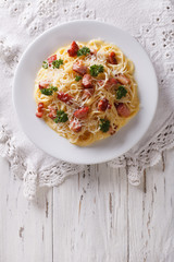 Italian pasta carbonara on a plate. vertical top view
