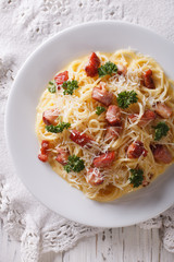 Italian pasta carbonara close-up on a plate. vertical top view
