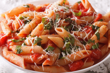Arrabiata pasta penne with Parmesan cheese macro. horizontal
