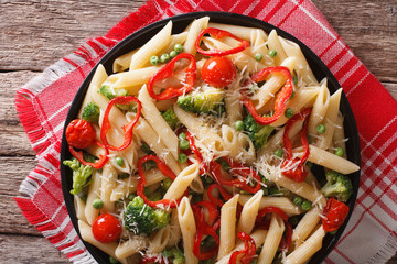 Italian pasta with vegetables close-up on a plate. horizontal top view
