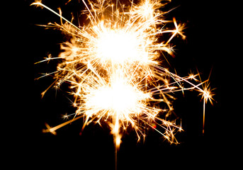 sparkler or bengal light burning over black