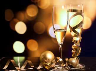 Toasting with champagne glasses against holiday lights