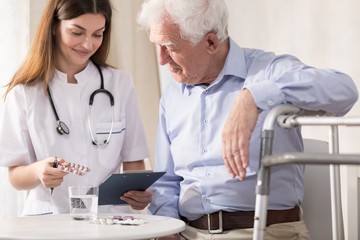 Nurse giving her patient medicines