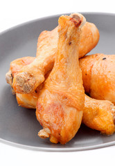 fried chicken thighs in dark porcelain dish