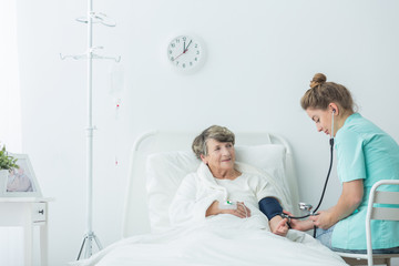 Obraz premium Carer measuring blood pressure