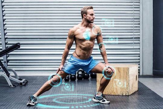 Composite image of muscular man doing leg stretchings