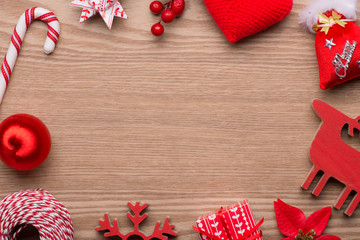 Beautiful christmas background: Collection of Red Christmas objects isolated on fir branches on wooden background with copyspace. View from above