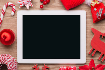 Beautiful christmas background: Collection of Red Christmas objects isolated on fir branches on wooden background with copyspace. View from above