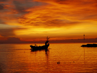Fishing boats at sea at sunrise
