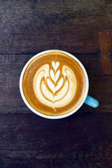 cup of latte art coffee on wooden background
