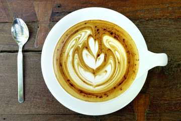 cup of latte art coffee on wooden background
