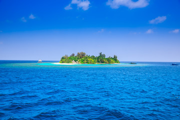 The solitary island and bungalows in the sea .