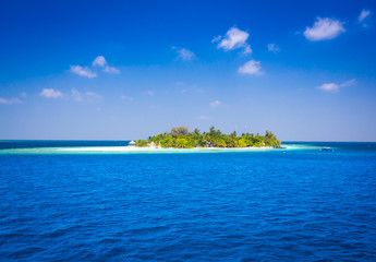The solitary island and bungalows in the sea .