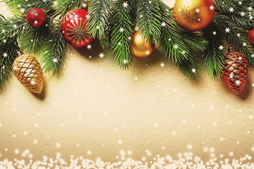 Christmas fir tree branches with toys on paper background
