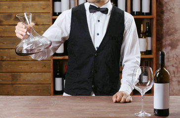 Bartender working at counter on bar background
