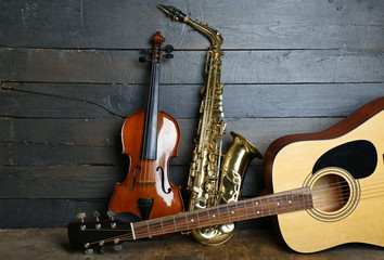 Musical instruments on wooden background - obrazy, fototapety, plakaty