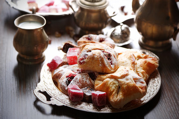 Antique tea-set with Turkish delight and baking on table close-up