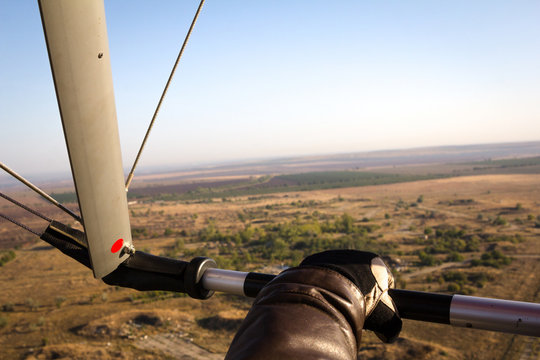 Hand paraglider pilot holding the bar