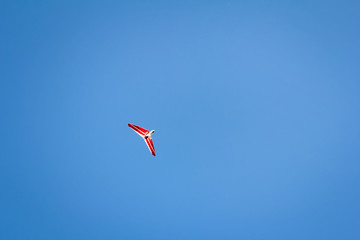 Motorized hang glider soaring in the blue sky