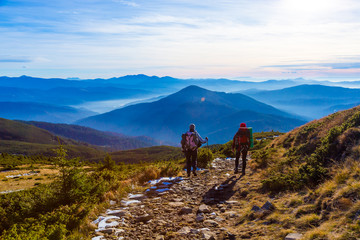 Sportive Couple walking on rural Road foggy Mountains Sunset