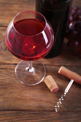 Wine and grapes on wooden background