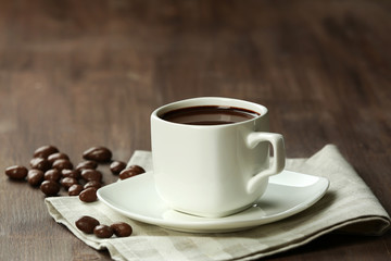 Cacao with sweets on wooden background