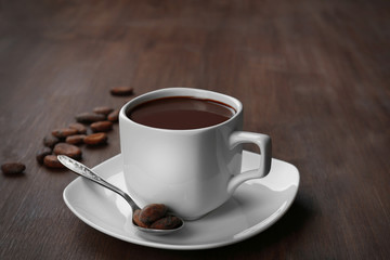 Cacao with beans and chocolate on wooden background