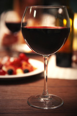 Glass with red wine on the table
